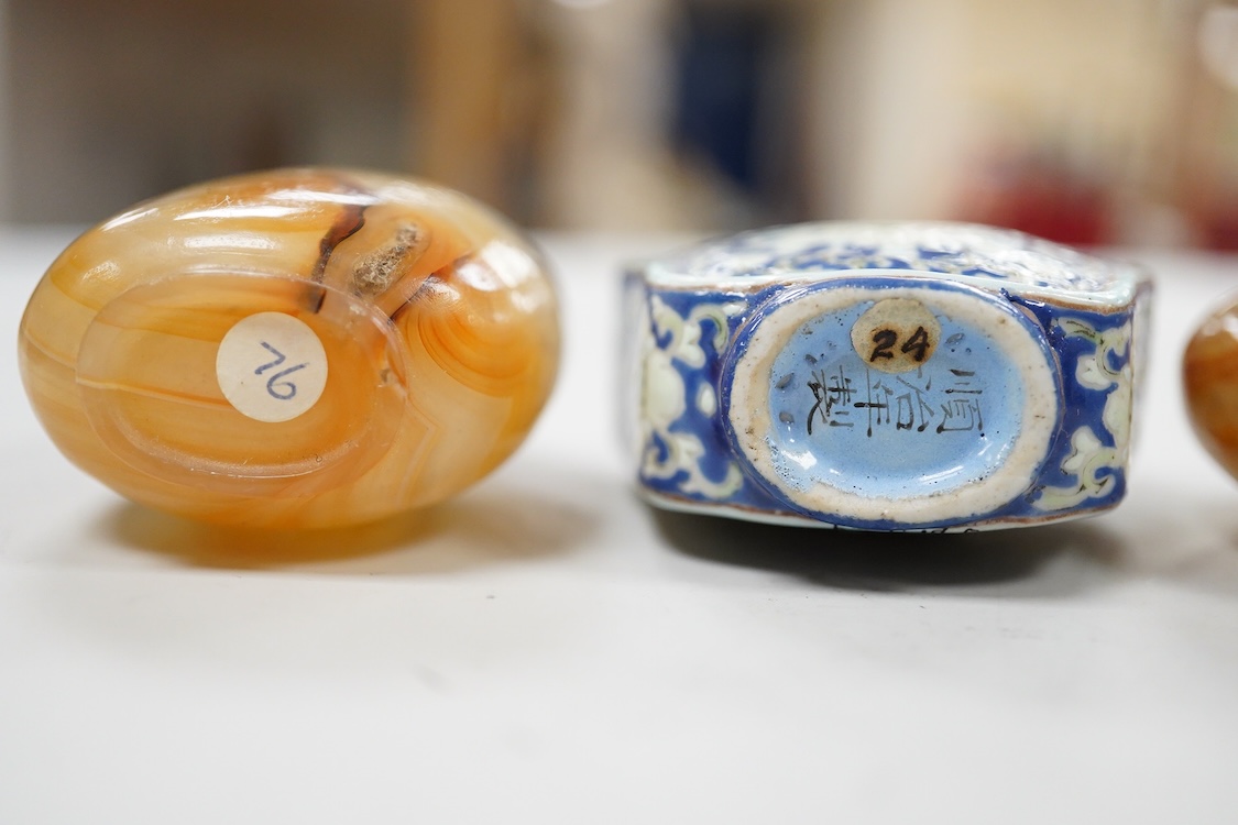 Three 19th century Chinese agate snuff bottles and a porcelain snuff bottle, largest 6cm high (4)